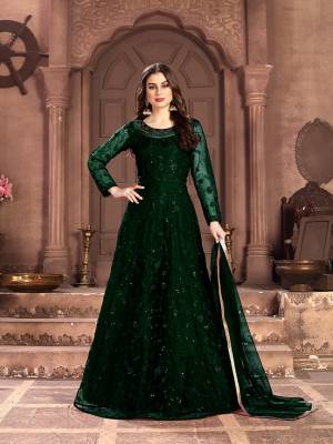 Adorn The Pretty Angelic Look Wearing This Designer Floor Length Suit In All Over Pine Green Color. Its Pretty Top Is Fabricated on Net Beautified With Pretty Tone To Tone Embroidery Giving A Heavy Yet Subtle Look Paired With Santoon Bottom And Net Fabricated Dupatta. Buy Now.