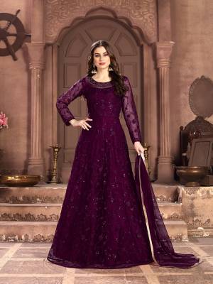 Adorn The Pretty Angelic Look Wearing This Designer Floor Length Suit In All Over Wine Color. Its Pretty Top Is Fabricated on Net Beautified With Pretty Tone To Tone Embroidery Giving A Heavy Yet Subtle Look Paired With Santoon Bottom And Net Fabricated Dupatta. Buy Now.
