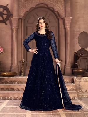 Adorn The Pretty Angelic Look Wearing This Designer Floor Length Suit In All Over Navy Blue Color. Its Pretty Top Is Fabricated on Net Beautified With Pretty Tone To Tone Embroidery Giving A Heavy Yet Subtle Look Paired With Santoon Bottom And Net Fabricated Dupatta. Buy Now.