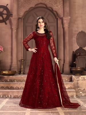 Adorn The Pretty Angelic Look Wearing This Designer Floor Length Suit In All Over Red Color. Its Pretty Top Is Fabricated on Net Beautified With Pretty Tone To Tone Embroidery Giving A Heavy Yet Subtle Look Paired With Santoon Bottom And Net Fabricated Dupatta. Buy Now.