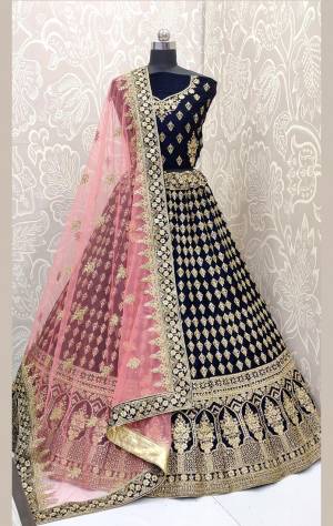 Here Is A Beautiful Designer Bridal Lehenga Choli In Navy Blue?Color Paired With Baby Pink Colored Dupatta. This Beautiful Heavy Lehenga Choli Is Fabricated On Velvet Paired With Net Fabricated Dupatta. It Is Beautified With Heavy Detailed Embroidery. Get Ready For Your D-Day With This Designer Piece And Look The Most Graceful Of All