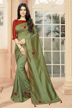Celebrate This Festive Season With Beauty And Comfort Wearing This Lovely And Elegant Looking Deisgner Saree In Olive Green Color Paired With Red Colored Blouse. This Saree And Blouse are Silk Based Beautified With 3D Flowers And Stone Work. 