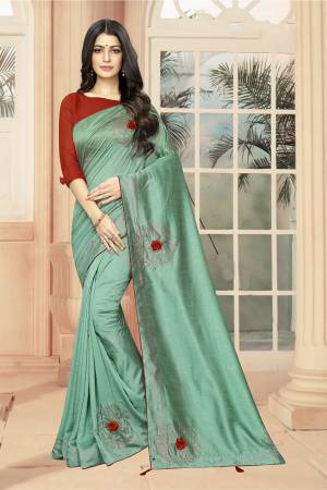 Add Some Semi-Casuals With This Pretty Designer Saree In Sea Green Color Paired With Red Colored Blouse. This Saree And Blouse are Fabricated On Art Silk Beautified With Stone Work And 3D Flowers. This Saree Is Light Weight And Easy To Carry All Day Long .
