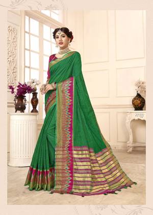 Here Is Proper Traditional Looking Designer Weaved Saree In Green Color Paired With Contrasting Rani Pink Colored Blouse. This Saree Is Fabricated on Cotton Silk Paired With Art Silk Fabricated Blouse. It Is Light Weight And Easy To Carry All Day Long. 