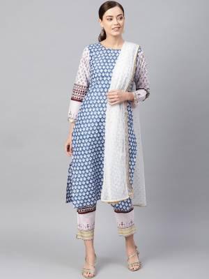 For Your Semi-Casual Wear, Grab This Readymade Printed Suit In White And Blue Color. Its Top And Bottom Are Cotton Based Paired With Net Fabricated Dupatta. Buy Now.