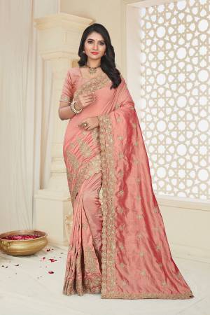 For A Rich And Elegant Look, Grab This Designer Embroidered Saree In Peach Color. This Saree And Blouse Are Silk Based Beautified With Attractive Jari Embroidery. Buy Now.