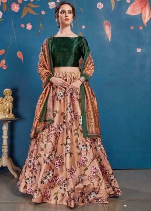 Go Colorful With This Lovely Designer Lehenga Choli In Pine Green Colored Blouse Paired With Contrasting Beige Colored lehenga And Light Orange Colored Dupatta. Its Blouse And Lehenga Are Fabricated On Art Silk Paired With Tussar Art Silk Fabricated Dupatta. It Is Beautified With Lovely Digital Prints. Buy Now.