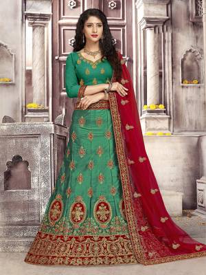 Look The Most Gorgeous Of All This Wedding Season With This Heavy Designer Lehenga Choli In Green Color Paired With Contrasting Red Colored Dupatta. Its Blouse Is Fabricated on Art Silk Paired With Satin Silk Lehenga And Net Fabricated Dupatta. Buy This Semi-Stitched Lehenga Choli Now.