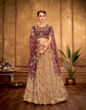 Weave a princess-y story with Fine feckles of gold on the regal maroon and beige lehenga embedded with sequins scalloped details apt for an evening soiree. 