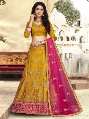 For A Proper Traditional Look, Grab This Heavy Designer Lehenga Choli In Musturd Yellow Color Paired With Contrasting Rani Pink Colored Blouse. Its Blouse Is Fabricated On Art Silk Paired With Satin Silk Lehenga And Net Fabricated Dupatta. It Is Beautified With Attractive Embroidery. Buy This Pretty Piece Now.