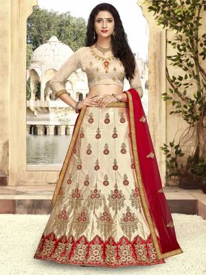 For A Proper Traditional Look, Grab This Heavy Designer Lehenga Choli In Beige Color Paired With Contrasting Red Colored Blouse. Its Blouse Is Fabricated On Art Silk Paired With Satin Silk Lehenga And Net Fabricated Dupatta. It Is Beautified With Attractive Embroidery. Buy This Pretty Piece Now.
