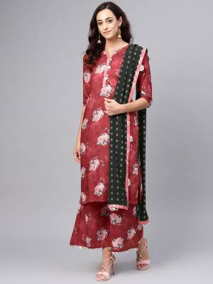 Simple And Elegant Readymade Suit Is Here In Maroon Color Paired With Black Colored Dupatta. This pair Is Fabricated On Muslin Paired With Georgette Fabricated Dupatta. 
