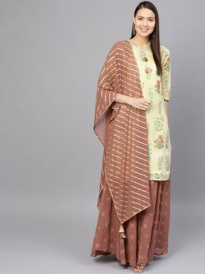 You Will Definitely Earn Lots Of Compliments Wearing This Designer Readymade Suit In Light Yellow Color Paired With Contrasting Brown Colored Bottom And Dupatta. Its Top Is Fabricated On Chanderi Paired With Georgette Fabricated Bottom and Dupatta. 