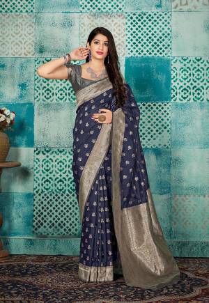 Celebrate This Festive Season Wearing This Pretty Saree In Navy Blue Color Paired With Grey Colored Blouse. This Pretty Weaved Saree And Blouse Are Fabricated On Banarasi Art Silk Which Gives A Rich Look To Your Personality. 