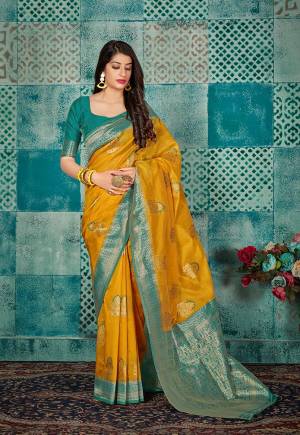 Celebrate This Festive Season Wearing This Pretty Saree In Musturd Yellow Color Paired With Sea Green Colored Blouse. This Pretty Weaved Saree And Blouse Are Fabricated On Banarasi Art Silk Which Gives A Rich Look To Your Personality. 