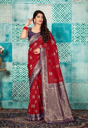 Celebrate This Festive Season Wearing This Pretty Saree In Red Color Paired With Purple Colored Blouse. This Pretty Weaved Saree And Blouse Are Fabricated On Banarasi Art Silk Which Gives A Rich Look To Your Personality. 