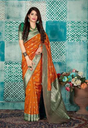 Celebrate This Festive Season Wearing This Pretty Saree In Rust Orange Color Paired With Green Colored Blouse. This Pretty Weaved Saree And Blouse Are Fabricated On Banarasi Art Silk Which Gives A Rich Look To Your Personality. 
