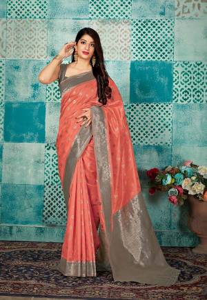 Celebrate This Festive Season Wearing This Pretty Saree In Dark Peach Color Paired With Grey Colored Blouse. This Pretty Weaved Saree And Blouse Are Fabricated On Banarasi Art Silk Which Gives A Rich Look To Your Personality. 
