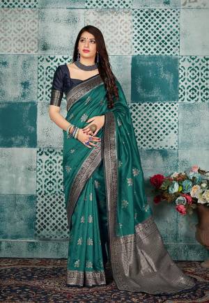Grab This Beautiful Designer Silk Based Saree In Sea Blue Color Paired With Contrasting Navy Blue Colored Blouse. This Saree And Blouse Are Fabricated On Banarasi Art Silk Beautified With Weave All Over. 