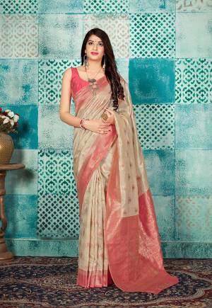 Celebrate This Festive Season Wearing This Pretty Saree In Cream Color Paired With Pink Colored Blouse. This Pretty Weaved Saree And Blouse Are Fabricated On Banarasi Art Silk Which Gives A Rich Look To Your Personality. 
