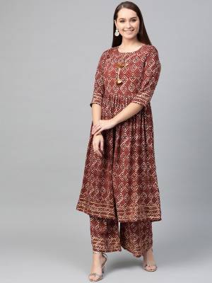 Here Is A Pretty Two-Piece Readymade Kurta Set On Brown Color. Its Kurti And Plazzo Are Fabricated on Cotton Beautified With Prints All Over .
