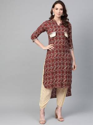 Grab This Readymade Kurta Set In Brwon colored Top Paired With Cream Colored Bottom. Its High Low Patterned Kurti Is Fabricated On Rayon Paired With Georgette Fabricated Bottom. 