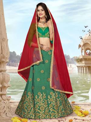 Grab This Designer Silk Based Lehenga Choli In Green Color Paired With Contrasting Red colored Blouse. Its Blouse And Lehenga Are Fabricated on Art Silk Paired With Net Fabricated Dupatta. Buy Now. 