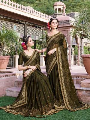 Grab This Heavy Designer Saree In Dark Olive Green Color Paired With Dark Olive Green Colored Blouse. This Heavy Embroidered Saree Is Fabricated On Georgette Paired With Art Silk Fabricated Blouse. It Is Easy To Drape And Carry All Day Long. 