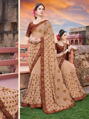 Shine Bright Wearing This Heavy Designer Saree In Beige Color Paired With Brown Colored Blouse. This Pretty Saree Is Georgette Based Beautified With Contrasting Embroidery Paired With Art Silk Fabricated Blouse. 