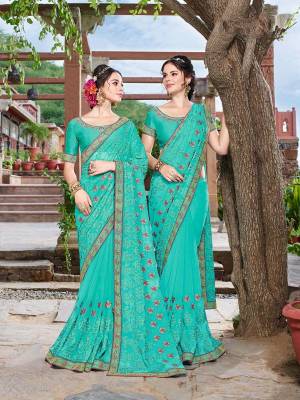 Adorn The Pretty Angelic Look Wearing This Heavy Designer Turquoise Blue Colored Saree Paired With Turquoise Blue Colored Blouse. This Saree Is Fabricated On Georgette Paired With Art Silk Fabricated Blouse. It Embroidery And Color Gives An Attractive Look To Your Personality. 