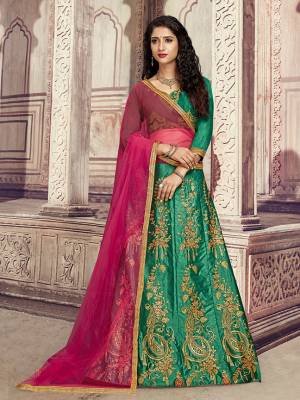 Here Is A Heavy Designer Lehenga Choli In Green Color Paired With Contrasting Rani Pink Colored Dupatta. Its Blouse Is Fabricated On Art Silk Paired With Satin Silk Fabricated Lehenga And Net Dupatta. Its Pretty Blouse And Lehenga Are Beautified With Embroidery Which Comes With A Net Dupatta With Lace Border. Buy Now.