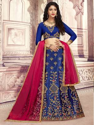 Here Is A Heavy Designer Lehenga Choli In Royal Blue Color Paired With Contrasting Rani Pink Colored Dupatta. Its Blouse Is Fabricated On Art Silk Paired With Satin Silk Fabricated Lehenga And Net Dupatta. Its Pretty Blouse And Lehenga Are Beautified With Embroidery Which Comes With A Net Dupatta With Lace Border. Buy Now.