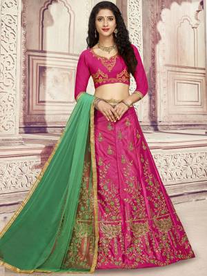Here Is A Heavy Designer Lehenga Choli In Rani Pink Color Paired With Contrasting Green Colored Dupatta. Its Blouse Is Fabricated On Art Silk Paired With Satin Silk Fabricated Lehenga And Net Dupatta. Its Pretty Blouse And Lehenga Are Beautified With Embroidery Which Comes With A Net Dupatta With Lace Border. Buy Now.