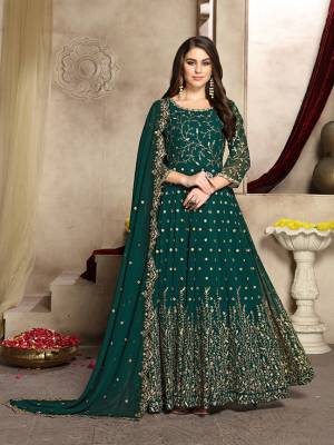Here Is A Prefect Outfit For This Festive And Wedding Season Wearing This Heavy Designer Floor Length Suit In Teal Green Color. Its Embroidered Floor Length Top And Dupatta are fabricated on Georgette Paired With Santoon Bottom. It Is Light In Weight and Easy To Carry All Day Long. Buy Now.