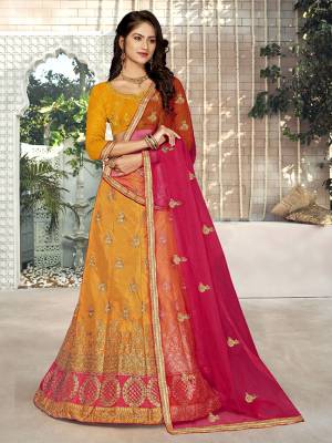 For A Proper Traditional Look, Grab This Heavy Designer Lehenga Choli In Musturd Yellow  Color Paired With Contrasting Dark Pink Colored Blouse. Its Blouse Is Fabricated On Art Silk Paired With Satin Silk Lehenga And Net Fabricated Dupatta. It Is Beautified With Attractive Embroidery. Buy This Pretty Piece Now.