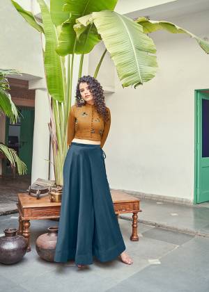 Another Designer pair Is Skirt And Crop Top Is Here For The Upcoming Festive And Wedding Seasoon. Its Top Is In Brown Color Paired With Blue Colored Skirt, This Readymade Is Silk Based Which Also Gives A Rich Look To Your Personality. 