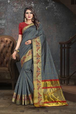 Flaunt Your Rich And Elegant Taste Wearing This Rich Looking Saree In Dark Grey Color Paired With contrasting Red Colored Blouse. This Saree Is Fabricated On Cotton Paired With Art Silk Fabricated Blouse. Buy Now.