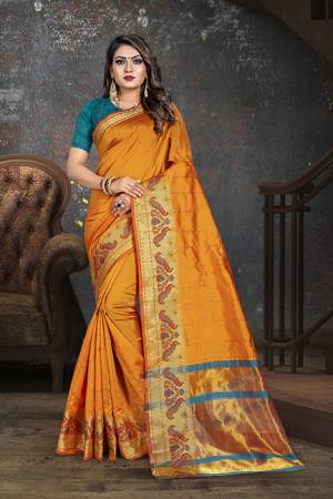 Celebrate This Festive Season With Beauty And Comfort In This Designer Orange Colored Saree Paired With Contrasting Blue Colored Blouse. This Saree Is Cotton Based Paired With Art Silk Fabricated Blouse.