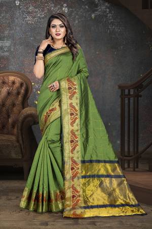 Flaunt Your Rich And Elegant Taste Wearing This Rich Looking Saree In Green Color Paired With contrasting Navy Blue Colored Blouse. This Saree Is Fabricated On Cotton Paired With Art Silk Fabricated Blouse. Buy Now.
