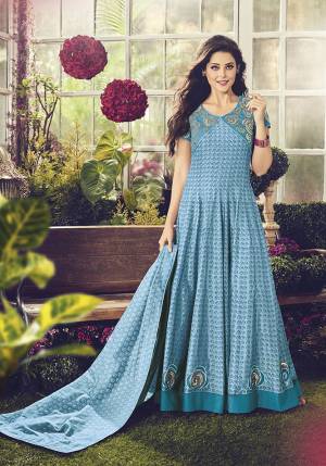Here Is A Beautiful Designer Floor Length Suit In Blue Color. ThisPretty Semi-Stitched Suit Is Cotton Based Beautified With Embroidery, It Is Light In Weight And Easy To Carry All Day Long. 