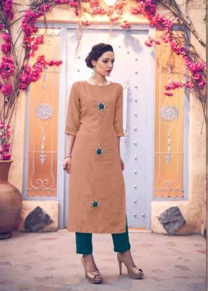 New And Unique Shade Is Here To Add Into Your Wardrobe With This Designer Readymade Kurti In Dusty Peach Color Paired With Contrasting Teal Blue Colored Bottom. This Pretty Pair Is Silk Based Beautified With Hand Work Butti. 