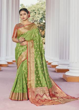 Classy Saree look pretty like never before.Wearing this Green Color Saree which made from Handloom Silk With Orange Color Handloom Silk blouse, Saree has also decorative work like Heavy Zari Work With Woven.This beautiful Saree features a classy Zari Work