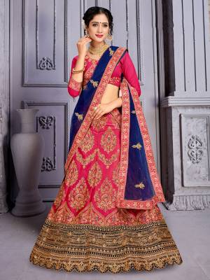 Catch All The Limelight At The Next Wedding You Attend Wearing This Heavy Designer Lehenga Choli In Dark Pink Color Paired with Contrasting Royal Blue Color Dupatta. Its Blouse Is Silk Based Paired With Satin Silk Lehenga And Net Fabricated Dupatta. Buy Now.