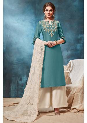 Celebrate This Festive Season With Beauty And Comfort In This Designer Readymade Suit In Steel Blue Colored Top Paired With Off-White Colored Bottom And Dupatta. Its Top Is Fabricated On Soft Silk Paired With Viscose Bottom And Net Fabricated Dupatta. 