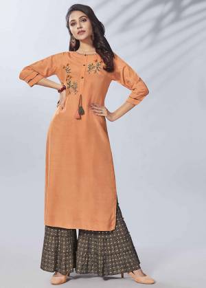 Grab This Beautiful Readymade Pair Of Kurti In Orange Color Paired With Dark Grey Colored Bottom. This Kurti Is Viscose Rayon Based Paired With Cotton Fabricated Bottom. It Is Beautified With Hand Work And Available In All Regular Sizes. 