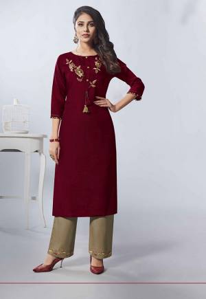 Flaunt Your Rich And Elegant Taste Wearing This Designer Readymade Kurti In Maroon Color Paired With Dark Beige Colored Bottom. This Kurti Is Fabricated on Viscose Rayon Beautified With Hand Work Paired With Cotton Fabricated Bottom. Buy Now.