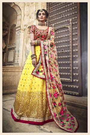 Go Colorful With This Heavy Designer Lehenga Choli In Red Colored Blouse Paired With Yellow Colored Lehenga And Cream Colored Dupatta. Its Pretty colorful Embroidered Blouse, Lehenga And Dupatta Are Fabricated On Net. It Is Light In Weight And Easy To Carry All Day Long. 