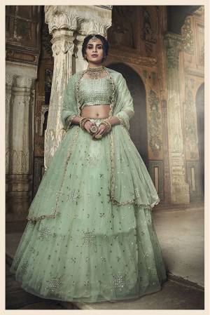 This Season Is About Subtle Shades And Pastel Play So Grab This Heavy Designer And Elegant Looking Lehenga Choli In Pastel Green Color. Its Pretty Heavy Embroidered Blouse Is Fabricated On Art Silk Paired With Net Fabricated Lehenga And Dupatta. Buy Now.