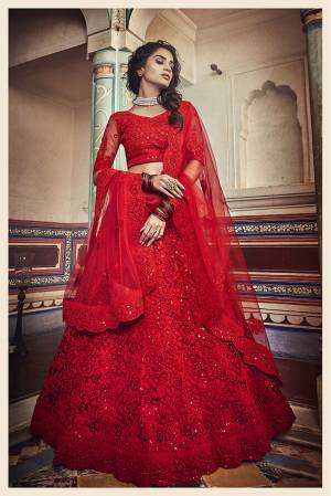 You Will Definitely Earn Lots Of Compliments Wearing This Heavy Designer Lehenga Choli In All Over Red Color. This Pretty Lehenga, Choli And Dupatta Are Net based Beautified With Tone To Tone Embroidery. 