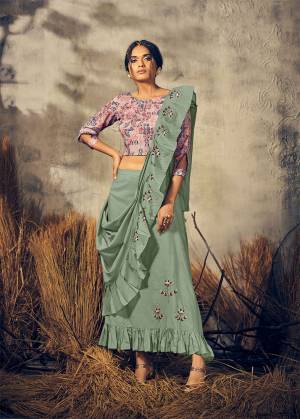Here Is A Very Beautiful Designer Readymade Indo-Western Dress In Pink Colored Blouse Paired With Dusty Green Colores Skirt And Dupatta. This Whole Dress Is Viscose Based Beautified With Print & Hand Work. 